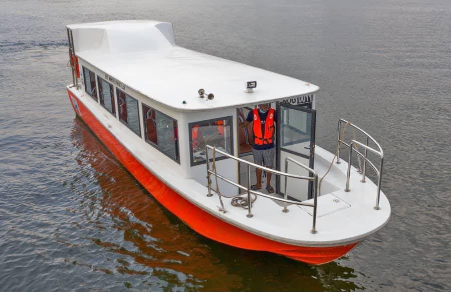 A covered passenger boat on the water