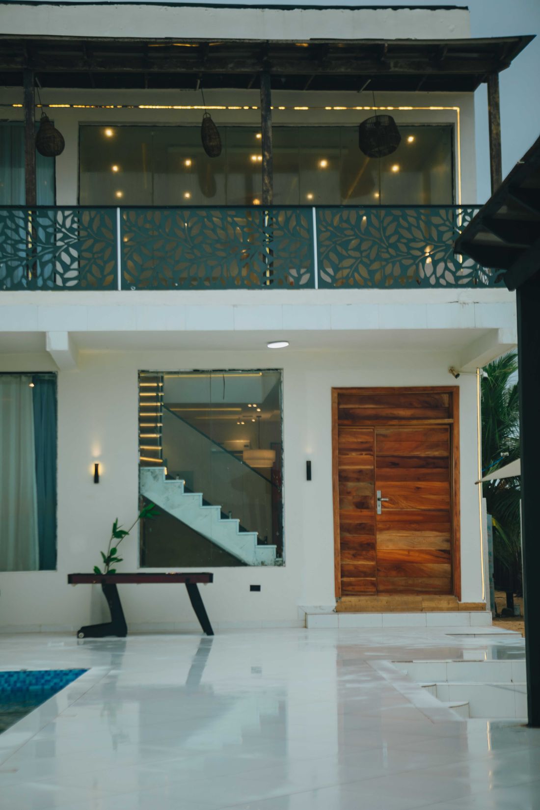 The entrance hall with a timber door and pale stone floor