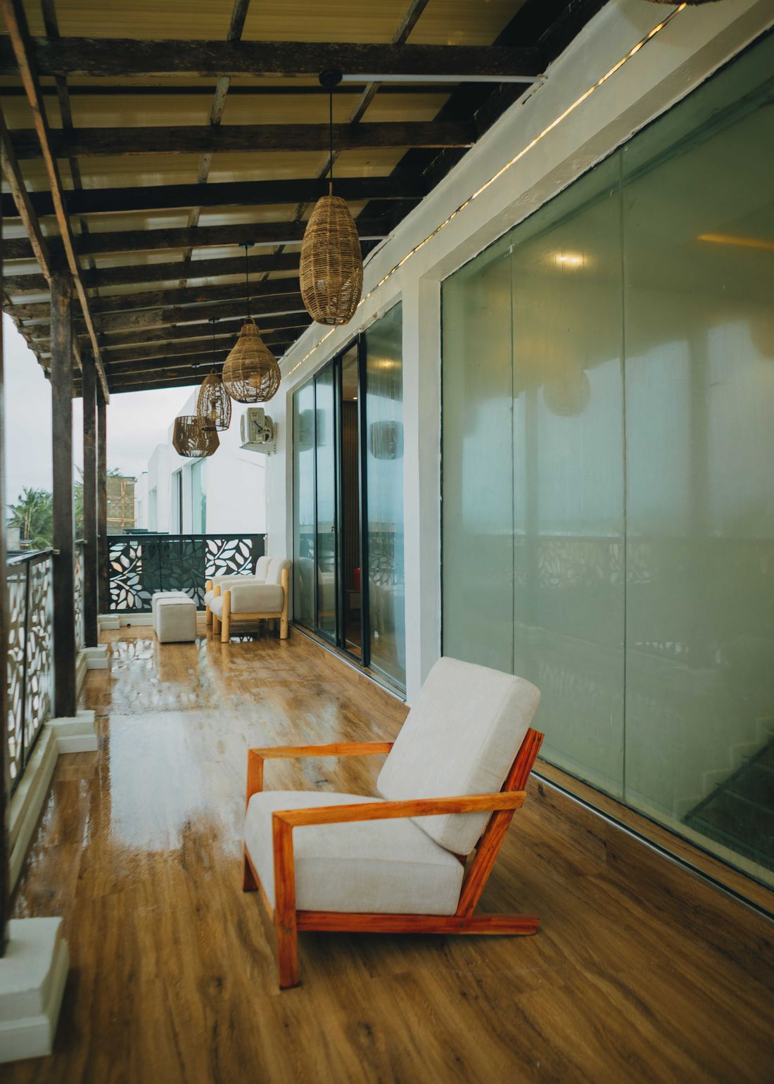 The upstairs verandah, lined with glass and rattan pendant lights
